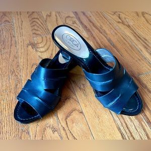 Joan and David black slides with wedge heel.